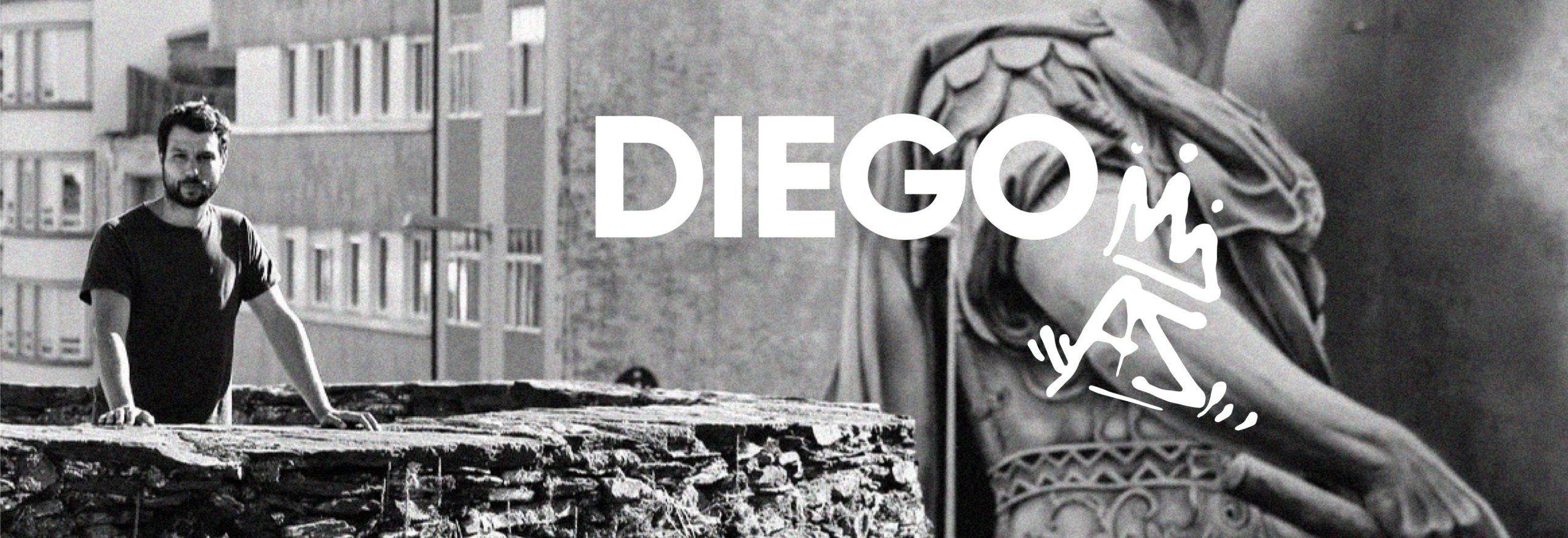 Foto de Diego posando en la muralla de Lugo con su graffiti del Julio Cesar de fondo y su firma DiegoAS