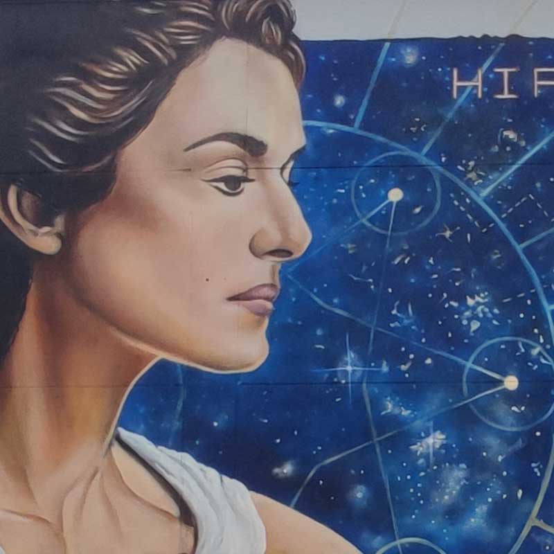 graffiti del perfil de Hipatia de Alejandría con las constelaciones de fondo